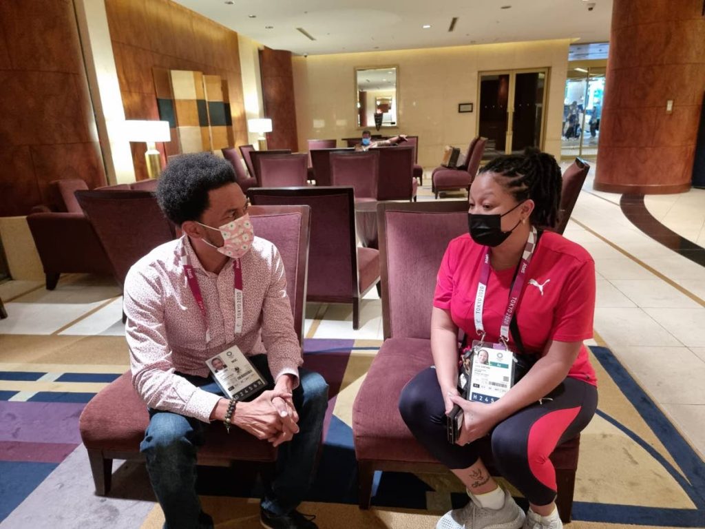 TTOC president Brian Lewis, left, in discussion with chef de mission Lovie Santana during the Olympic Games in Tokyo, Japan. -