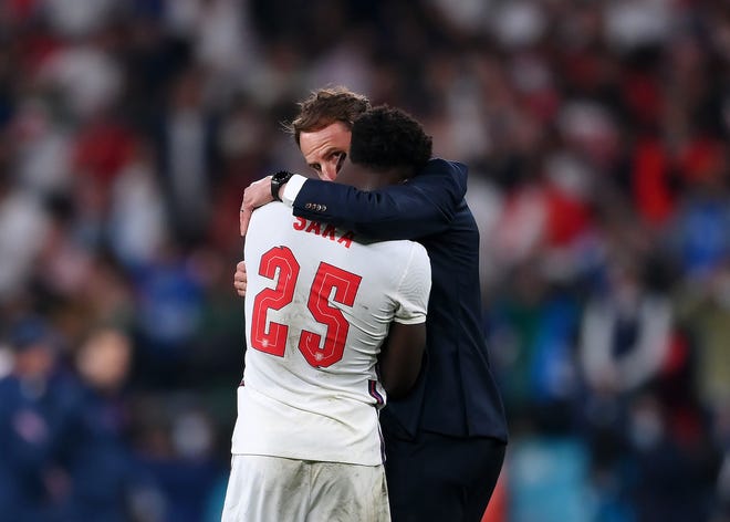 England's Bukayo Saka was consoled by his head coach, Gareth Southgate, after his penalty miss Sunday in the Euro 2020 Championship Final.