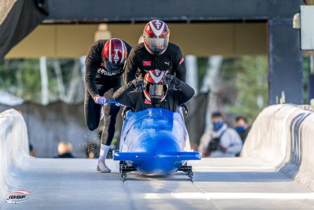 (front to back) TT bobsled team members Axel Brown, Shomari John, Tom Harris and Shakeel John (partially hidden) take part in a recent tournament. - Photo courtesy Intl Bobsleigh and Skeleton Federation