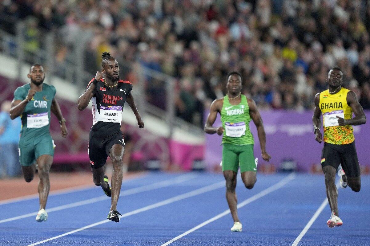 MAKING DREAMS COME TRUE: Jereem Richards of Trinidad and Tobago, second left, looks across the track as he leaves Emmanuel Eseme of Cameroon, left, Udodi Chudi Onwuzurike of Nigeria, second right, and Paul Amoah of Ghana in his wake in the Commonwealth Games Men’s 200 metres final at the Alexander Stadium in Birmingham, England, yesterday. —Photo: AP (via: trinidadexpress.com)