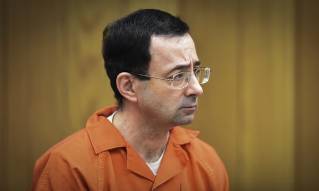 Larry Nassar, the former sports doctor who admitted molesting some of the nation's top gymnasts, appears in Michigan’s Eaton county court in 2018. Photograph: Matthew Dae Smith/AP (Image obtained at theguardian.com)