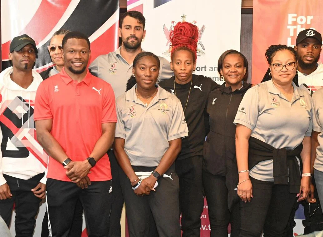 BACk HOME: Cyclist Nicholas Paul, third from left, swimmer Dylan Carter, fourth from left, and Michelle-Lee Ahye, fourth from right, were among several of the athletes who were at the VIP lounge of the Piarco International Airport yesterday on their return from the Paris Olympics. Chef de Mission Lovie Santana, second from right, also accompanied them home. —Photo: CURTIS CHASE (Image obtained at trinidadexpress.com)