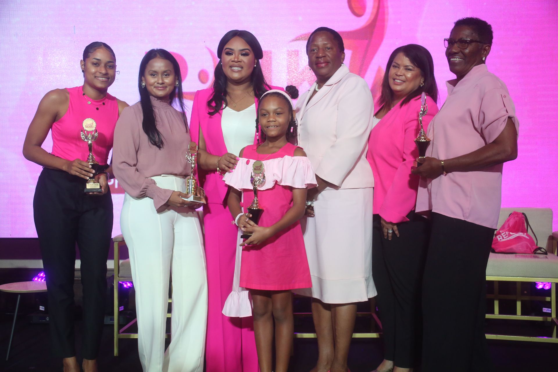 Minister of Sport and Community Development Shamfa Cudjoe-Lewis third from left, Minister of Planning and Development Pennelope Beckles-Robinson and US Embassy political assistant/attorney-at-law Debra Coryat-Patton pose for a photo with the most engaged on social media, left Gabrielle Barkley, winner of the Pink Reign 2023 Ariana Jeannine Parma, youngest participant Arya Joseph and most senior participant Ingrid Muriell during the Ministry of Sport and Community Development launch of the 2024 Pink Reign Campaign yesterday at Hilton Trinidad and Conference Centre, Port-of-Spain.  SHIRLEY BAHADUR (Image obtained at guardian.co.tt)
